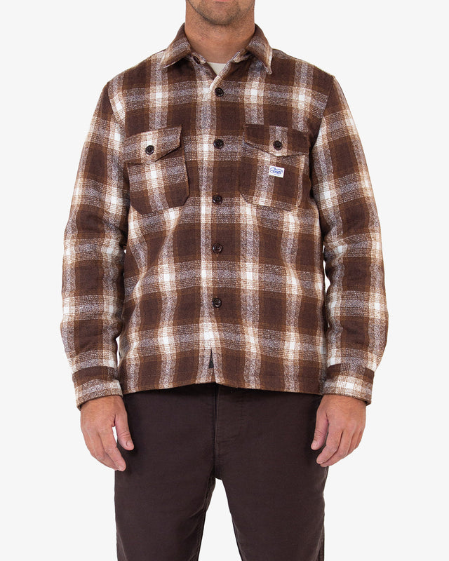 brown relaxed fit overshirt with yarn dyed check and chest branded label, quilted padded lining, wool and poly blend fabrication with light garment wash