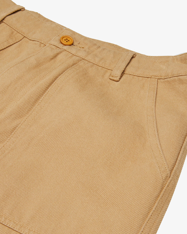 tan relaxed fit pant with front and back patch pockets, zip fly and branded label above back pocket, 100% cotton twill fabrication with a heavy enzyme stone wash