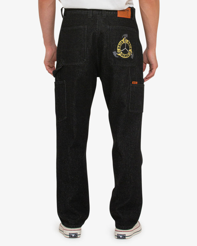 black relaxed fit pant with zip fly and shank button closure, embroidered artwork on back pocket, branded leather patch in a black 100% cotton denim twill fabrication