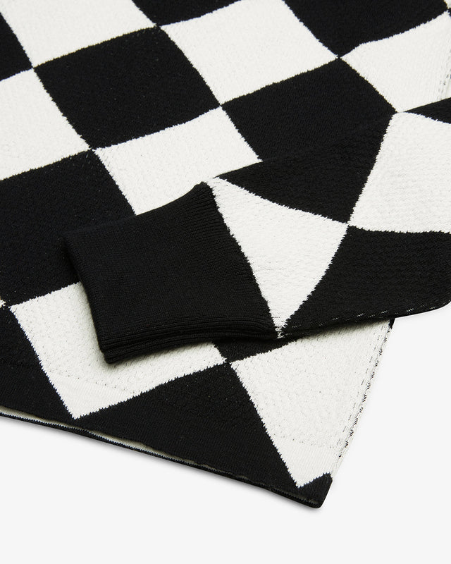 black and white regular fit true knit with jacquard check all over design, cotton appliqué front art, 100% cotton sub waffle knit fabrication with a garment wash