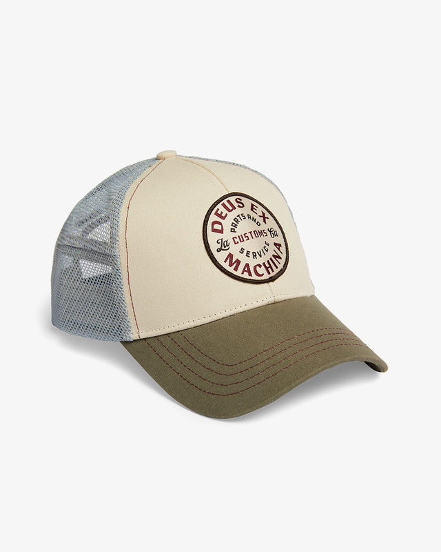 tan classic trucker hat with front woven patch and back embroidered logo, plastic snap adjuster, 100% cotton twill fabrication